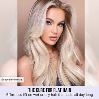 Woman with long, wavy blonde hair against a neutral background
