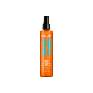 Orange spray bottle of Matrix Mega Sleek hair product on a white background