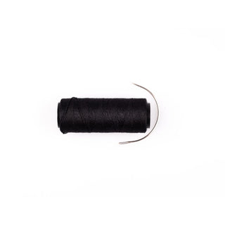 Spool of black thread on a white background