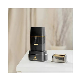 Andis electric shaver on a white surface with a neutral background
