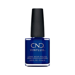 A bottle of CND Vinylux Long Wear Nail Polish in a deep cobalt blue shade, featuring a black cap and clear glass bottle, set against a plain white background.