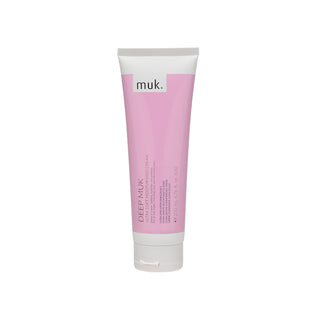Pink tube of muk Deep Milk cream on a white background