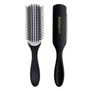Black hairbrushes with Denman logo on a white background