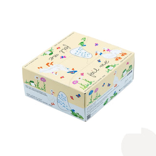 A square decorative gift box with a cream-colored top and sides, decorated with whimsical illustrations of white ducks, colorful flowers, green grass, and handwritten-style text reading FOIL ME and 'to the best of my ability.' The box is photographed on a clean white background.