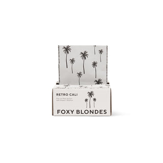 Foxy Blondes hair product packaging with palm tree design on a white background