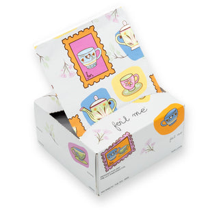 Box of tea bags with colorful teacup designs on a white background