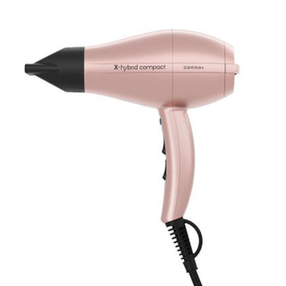 Rose gold hair dryer with black nozzle on a white background