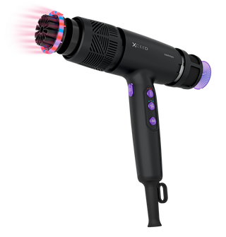 Black hair dryer with attachments on a white background