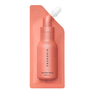 Coral-colored serum bottle with dropper on a matching pouch against a white background