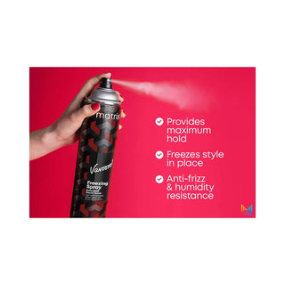 A hand holding a can of Vanish Freeze Spray against a bright pink background, with the spray mist visible and text on the right listing product benefits.