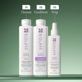 Three Biolage hair care products labeled 'Cleanse', 'Condition', and 'Prep' on a green background.