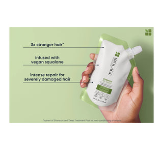Hand holding a white hair treatment pack with green background and text highlighting benefits