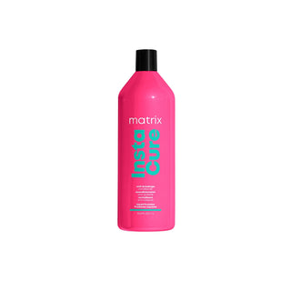 Pink bottle of Matrix Insta Cure conditioner on a white background