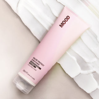 A pink tube of MOOD Color Protect Conditioner designed for moisturising dyed or treated hair advertising image.