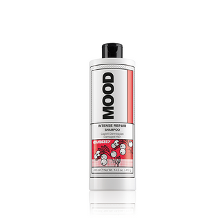A bottle of MOOD Intense Repair Shampoo with a white and red label, designed for dry and damaged hair.