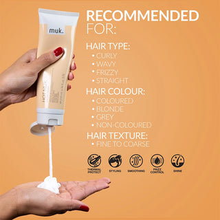 Hand holding a tube of muk hair product with application on palm, against an orange background