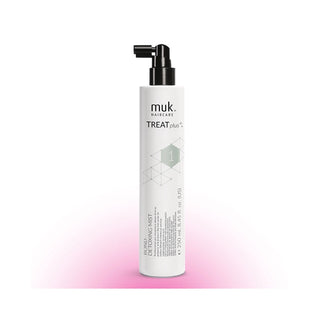 A white cylindrical pump bottle of muk. haircare TREAT plus+ Bond Repair Kissing Spray with a black nozzle, set against a white background with a soft pink glow at the bottom.