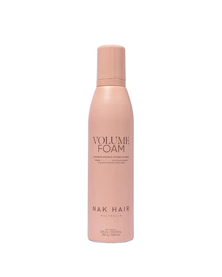 Pink bottle of NAK Hair Volume Foam on a white background