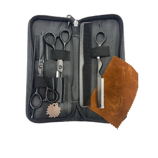 Set of grooming tools including scissors and a comb in a black case with a brown cloth on a white background.