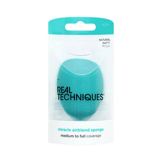 Teal makeup sponge in packaging with 'Real Techniques' branding on a white background