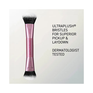 A dual-ended makeup brush with pink metallic ferrules and black-and-white bristles, shown next to marketing text that reads 'ULTRAPLUSH BRISTLES FOR SUPERIOR PICKUP & LAYDOWN' and 'DERMATOLOGIST TESTED'.