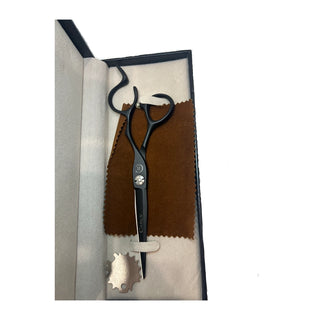 Black hair cutting scissors in a case with brown and beige interior
