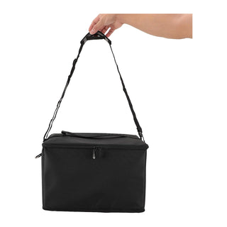 Black insulated cooler bag with a hand holding the strap on a white background