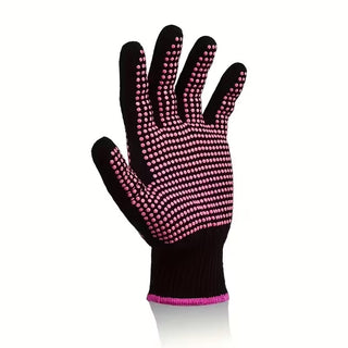 Black glove with pink textured palm on a white background