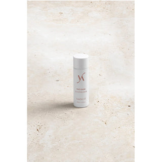 White skincare product bottle with 'Yanit' branding on a light beige background