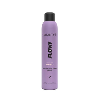 A lavender purple aerosol can of Vitality's Flowy Texturizing Shampoos Spray with a black cap, centered on a plain white background.