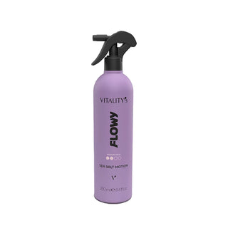 A lavender purple spray bottle of Vitality's Flowy Sea Salt Motion hair product, featuring a black trigger sprayer, on a solid white background.