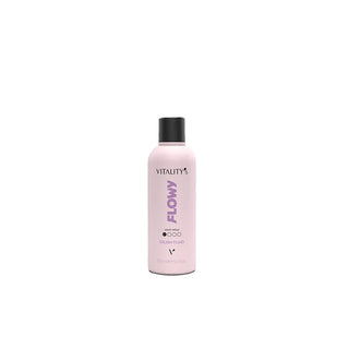 A light pink bottle of Vitality Flowy Hair Volume Volumizing Spray with a black cap, centered on a plain white background.