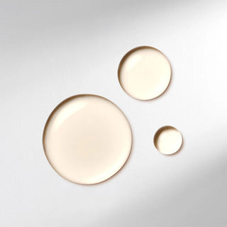Three round, beige ceramic plates of different sizes on a light gray background