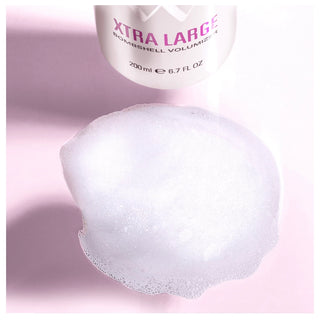 Shampoo bar with 'Xtra Large' container on a pink background